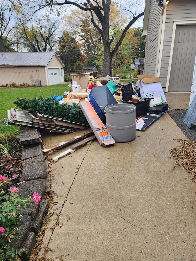 Dumpster being loaded with debris for 10 Yard Dumpster Rental in West Wendover